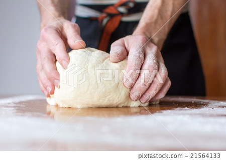 Baker makes bread on the table Baker makes bread on the table 21564133