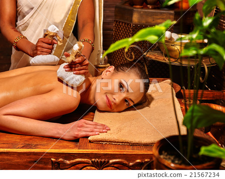 Woman having massage with pouch of rice. 21567234