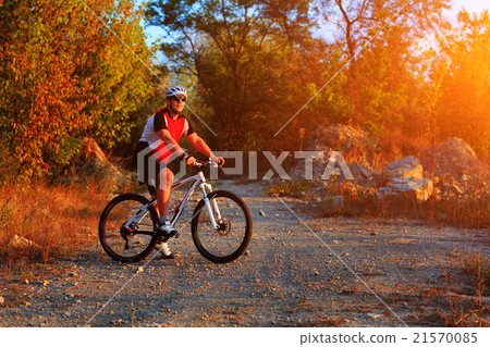 Active man on bike with nature background Active man on bike with nature background 21570085