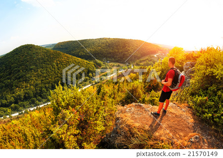 Active tourist on the top of mountain enjoying Active tourist on the top of mountain enjoying 21570149