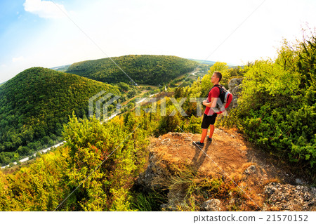 Active tourist on the top of mountain enjoying 21570152