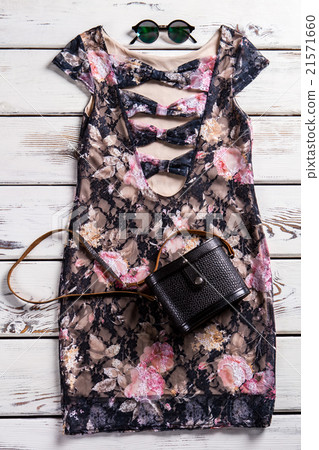 Stylish evening clothes on shelf. 21571660
