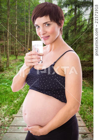 Composite image of pregnant woman drinking glass of water Composite image of pregnant woman drinking glass of water 21571918