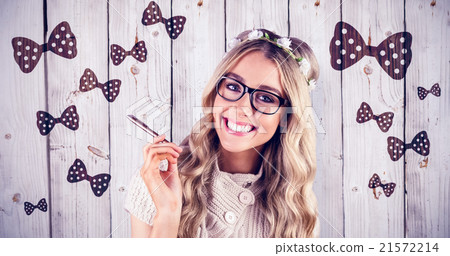 Composite image of gorgeous smiling blonde hipster holding pen 21572214