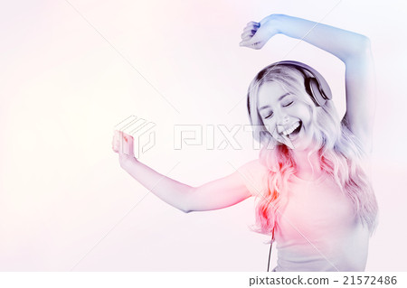 Composite image of beautiful woman dancing with headphones Composite image of beautiful woman dancing with headphones 21572486