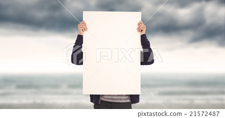Composite image of man showing billboard in front of face 21572487