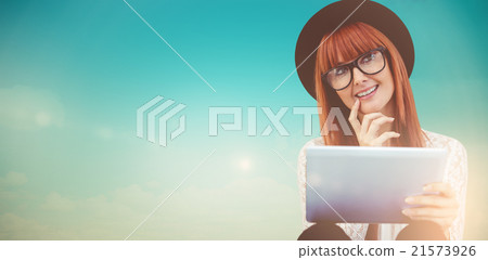 Composite image of smiling hipster woman using her tablet Composite image of smiling hipster woman using her tablet 21573926