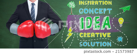 Composite image of businessman with boxing gloves 21573987