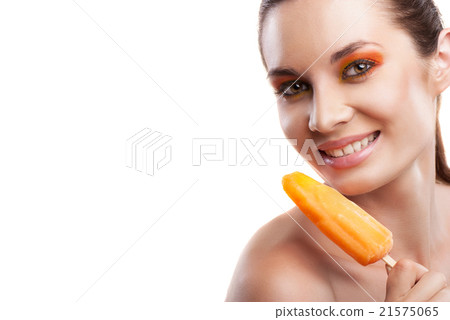 Woman eating orange ice-cream and having fun Woman eating orange ice-cream and having fun 21575065