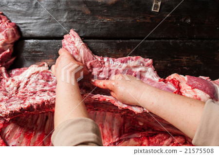 Butchery shop. Butcher separate meat from ribes. Butchery shop. Butcher separate meat from ribes. 21575508