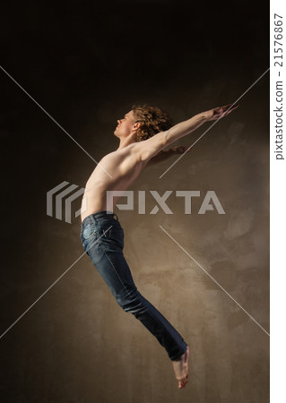 Young and stylish modern dancer on grey background 21576867