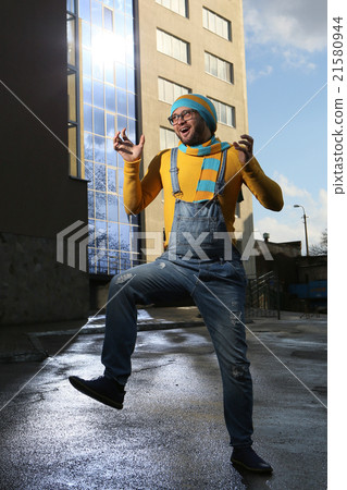young man on the street in overalls young man on the street in overalls 21580944