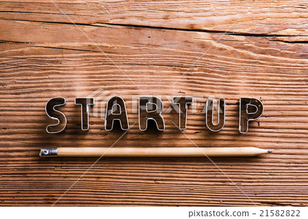 Office desk with start up sign and pencil. 21582822