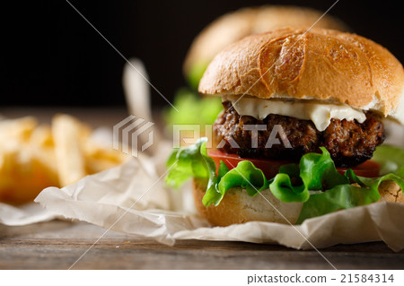 Homemade tasty burger and french fries on wooden Homemade tasty burger and french fries on wooden 21584314