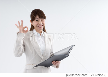 A woman who issues an OK sign A woman who issues an OK sign 21589542