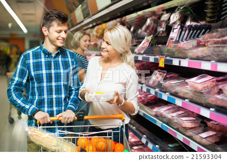 Smiling family couple choosing chilled meat 21593304