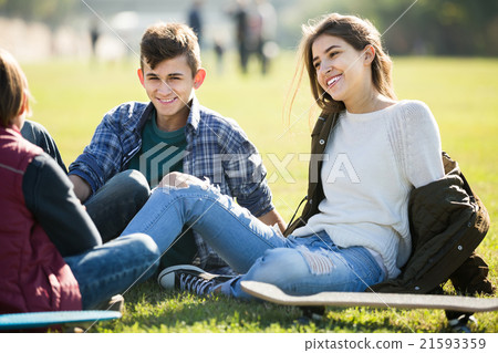 teenagers hanging out outdoors and discussing something 21593359