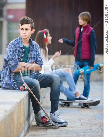 teen and his friends after conflict outdoors teen and his friends after conflict outdoors 21593397