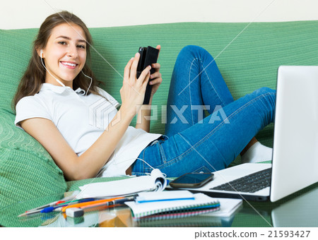 young girl using laptop at home young girl using laptop at home 21593427