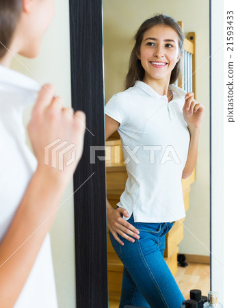 Young girl trying on a t-shirt 21593433