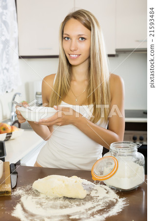 Smiling housewife cooking with dough Smiling housewife cooking with dough 21593484