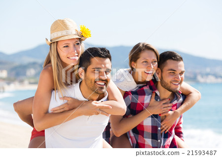 Two young couples on sand beach. 21593487
