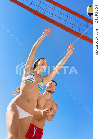 Young laughing couple playing volleyball 21593553