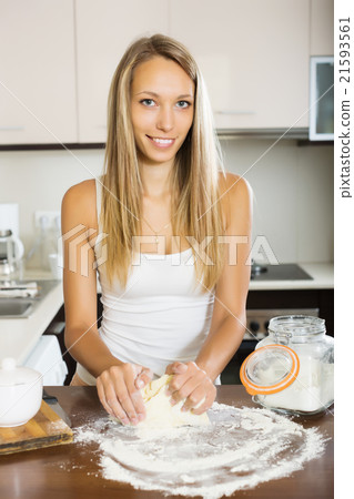 Smiling housewife cooking with dough 21593561