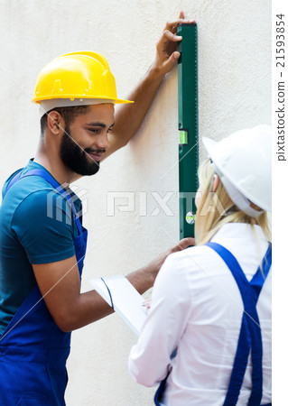 Smiling technicians smoothing the wall Smiling technicians smoothing the wall 21593854