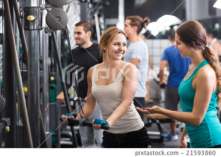 Adults doing powerlifting on machines Adults doing powerlifting on machines 21593860