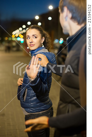 Couple having quarrel in evening outdoors. 21594152