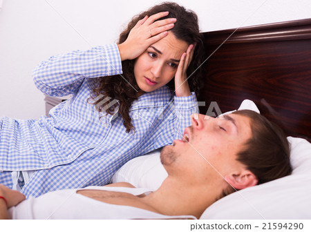 Angry girl tired of loud boyfriend snore 21594290