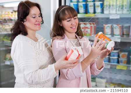 Cheerful women purchasing dairy products 21594510