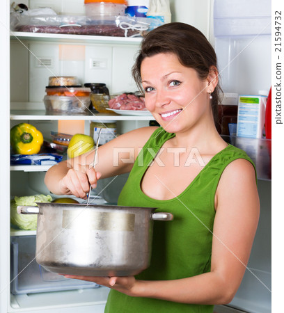 Girl eating soup from pan 21594732
