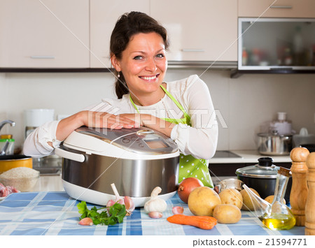 Happy woman using slo-cooker 21594771