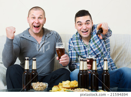 Two male sport fans watching game at home 21594894