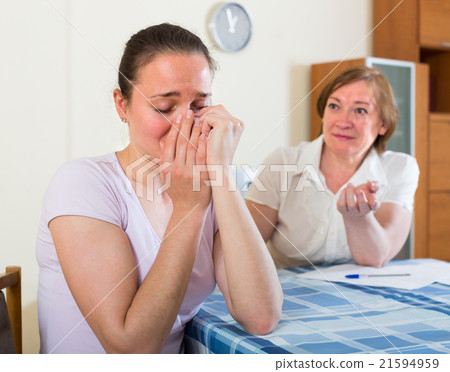 Sad mother and daughter with documents 21594959