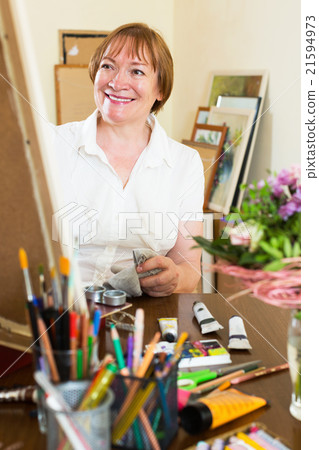 Artist creating a new picture at art studio Artist creating a new picture at art studio 21594973