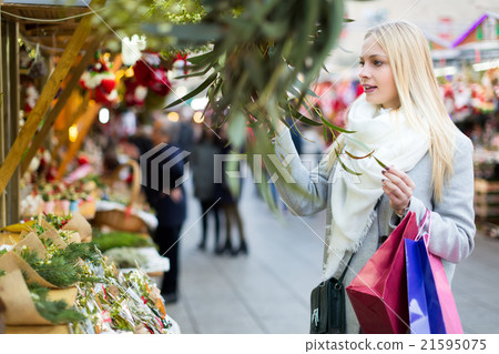 Woman buying a mistletoe Woman buying a mistletoe 21595075