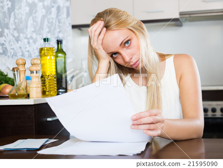 Sad blonde girl reading document 21595090