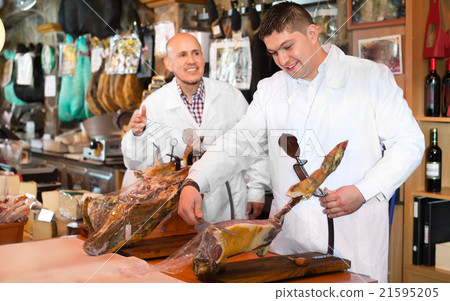 Workers slicing jamon. Workers slicing jamon. 21595205