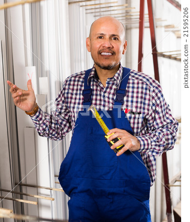 workman working at PVC frames workman working at PVC frames 21595206