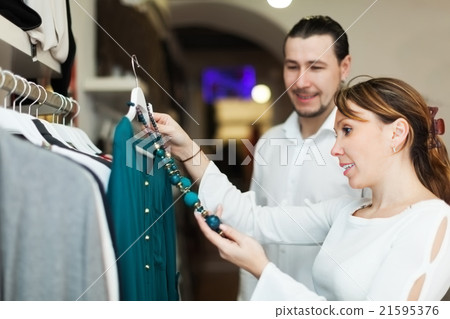 couple choosing clothes at market couple choosing clothes at market 21595376