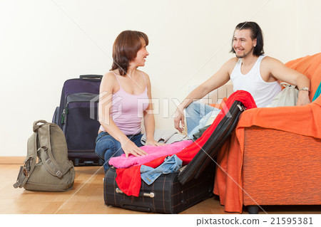 couple with luggage in home going on holiday couple with luggage in home going on holiday 21595381