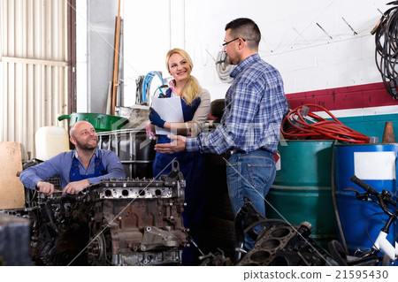 Service crew and driver near car 21595430