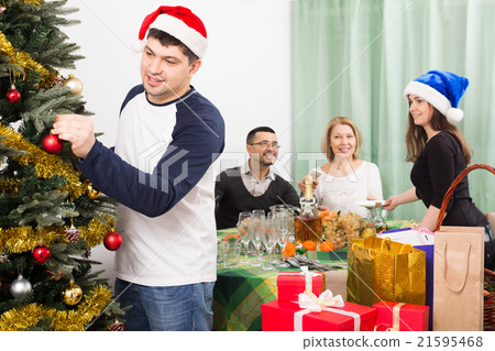 Mature parents with adult kids preparing for Christmas Mature parents with adult kids preparing for Christmas 21595468