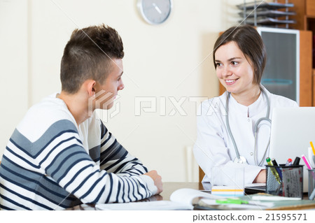 doctor receiving and questioning teen patient at office doctor receiving and questioning teen patient at office 21595571
