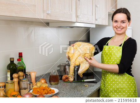 Housewife posing with capon 21595618