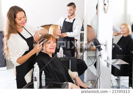Mature woman in the barbershop. 21595813