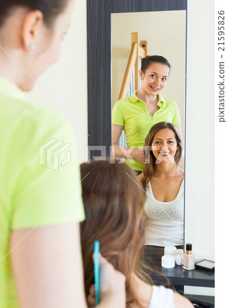 Smiling girl doing hairstyle 21595826